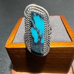 Condition: Pre-Owned / Good Metal: Sterling Silver Band Width: 3.5mm - 10.5mm Stone Type: Turquoise Maker: Native American Made Markings: None Stone Size: 25mm X 8.5mm Ring Size: 7.5 Item Weight: 5.9 Grams Black Turquoise, Sterling Silver Bands, Ring Size 7, Turquoise Jewelry, Womens Jewelry Rings, American Made, Silver Band, Bright Blue, Vintage Sterling Silver