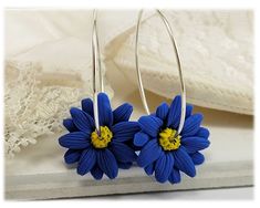 Lightweight style handcrafted Blue Aster hoop earrings on a choice of 20 gauge 925 sterling silver or 14k gold filled 1 inch hoops. -Original hand sculpted polymer clay flowers -Durable, water-resistant -No molds, no paint -Hoop size : 1 inch -20 gauge hoops - choose 925 sterling silver or 14k gold filled View matching collection at: https://www.etsy.com/shop/strandedtreasures/search?search_query=aster Flowers are hand sculpted without molds or paint using polymer clay, a durable water-resistant Blue Everyday Flower Jewelry, Blue Flower-shaped Hoop Earrings, Blue Flower Shaped Hoop Earrings, Blue Flower Hoop Earrings As Gift, Blue Flower Hoop Earrings Gift, September Birth Flower, Aster Flower, Gothic Earrings, Gold Filled Hoops