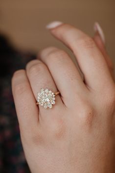 a woman's hand with a diamond ring on it