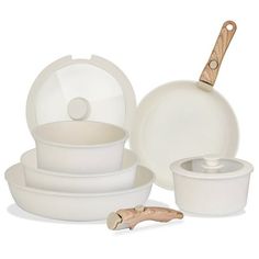 white dishes with wooden spoons and lids on a white background, one is empty