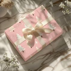 a pink gift box with a bow on it