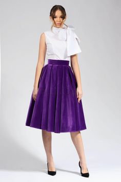 This purple velvet circle skirt is a must-have for any woman's wardrobe. It's made from 100% cotton, so it's both soft and elegant. The skirt has a high waist and a full circle skirt, which gives it a flattering and feminine look. The skirt is also lined, so it's comfortable to wear. This skirt is perfect for any occasion, from a night out to a special event. It can be dressed up or down, depending on the occasion. The purple color is versatile and can be paired with a variety of tops and access Chic Velvet Party Skirt, Party Pleated Cotton Skirt, Cotton Long Skirt For Party, Flared Cotton Skirt For Party, Party Full Skirt In Cotton, Cotton Full Skirt For Party, Purple Skirt Outfit, Velvet Circle Skirt, Cocktail Skirt