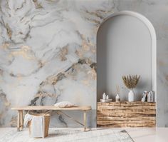 a white and gold marbled wall in a living room with a bench next to it