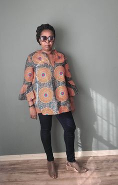 This beautiful African print tunic is made out of 100% wax cotton. It is an easy pull on top with no zippers or buttons. It can be worn for any occasion by styling it differently. Include your measurements in the order notes so we can make sure you are selecting the right fit. DETAILS & CARE - Full Length 30 inches - Sleeve length 24 inches - V-neck - Three-quarter sleeves - Pleat in the back - 100% wax cotton - Hand or machine wash cold recommended to preserve color brilliance Multicolor Smock Blouse With Long Sleeves, Multicolor Long Sleeve Smocked Blouse, Multicolor Long Sleeve Smock Blouse, Multicolor Long Sleeve Tunic With Block Print, Ladies Long Top, African Print Tops, Top With Long Sleeves, African Print Fashion Dresses, African Wax Print