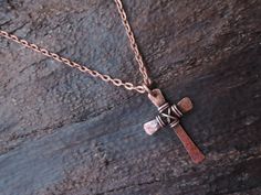 "This hammered solid copper metalwork cross is a totally handmade piece of jewelry that can be for him or her! The cross has wire wrap around the center to add to its rustic look. A patina is added to the cross for a vintage weathered look. As a final touch, the cross is polished and sealed to avoid natural oxidation process. It measures about 1.3 inches x 0.9 inches / 3.2 cm x 2.2 cm. The pendant is hung on a 1/8\" / 2.5 mm genuine leather cord featuring a secure handmade hook fastener. As defa Copper Cross Jewelry For Gifts, Rustic Cross Jewelry For Gifts, Rustic Cross Jewelry Gift, Bronze Cross Pendant Necklace For Gift, Jewelry Rustic, Hammered Jewelry, Mens Crosses, Rustic Jewelry, Nail Jewelry