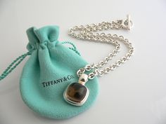 Overview:Offered for sale is a wonderful, very rare and gorgeous Tiffany & Co. Silver & Large Smoky Quartz Gemtone Toggle necklace. Definitely a Tiffany piece that you will get your money's value for. It works perfectly with pretty much any attire your put on, AND is an awesome statement piece. It is the perfect necklace that fits a lifestyle on the go -- the piece can be worn to pretty much any occasion! It is simple, elegant, and classic all rolled into one. Imagine wearing the piece with your Designer Polished Finish Necklaces For Formal Occasions, Designer Engraved Necklace For Gift, Designer Hallmarked Jewelry For Collectors, Designer Oval Jewelry For Gift, Designer Oval Jewelry Gift, Designer Engraved Necklaces For Formal Occasions, Designer Polished Finish Necklace Gift, Designer Oval Hallmarked Jewelry, Designer Silver Collectible Jewelry