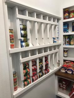 an organized pantry with canned food items on shelves