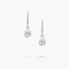 The Classic Graff collection presents eternally elegant diamond jewellery, including these drop earrings. Two precisely matched round diamonds, are suspended from two smaller round stones. Selected for their exceptional purity and fire, they are complemented by slender swan hooks embellished with gently graduated pavé diamonds. Exquisitely crafted to accentuate the brilliant beauty of the round diamonds, these sleek and timeless earrings are designed to be cherished for a lifetime. Graff Jewelry, Diamond Shaped Engagement Ring, Graff Diamonds, Round Diamond Earrings, Diamond Solitaire Earrings, High Jewellery, Engagement Ring Shapes, Solitaire Earrings, Bridal Engagement Rings