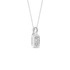 Embrace elegance with our Twisted Emerald Bezel Pendant Necklace. It features a brilliant emerald-shaped lab-grown diamond, delicately set in a sleek bezel setting, ensuring it catches the light from every angle. The twisted bail design adds a unique twist, symbolizing the intertwining of classic and contemporary styles. Whether dressing up for a special occasion or adding a touch of sophistication to your everyday look, this diamond pendant necklace is the perfect choice. Classic Emerald Pendant Necklace With Diamond Cut, Classic Diamond Cut Emerald Pendant Necklace, Classic Emerald Diamond Cut Pendant Necklace, Classic Emerald Necklace With Diamond Cut For Formal Occasions, Classic Diamond Cut Emerald Necklace For Formal Occasions, Classic Diamond-cut Emerald Necklace For Formal Occasions, Classic Emerald Pendant Necklace With Diamond Accents, Fine Jewelry Emerald Cut Diamond Necklace With Prong Setting, Classic Emerald Necklace With Prong Setting