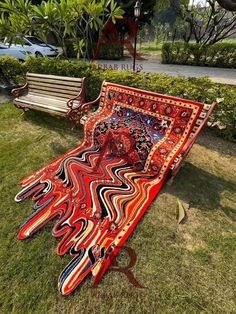 two benches sitting in the grass next to each other on top of a patch of grass