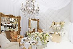 a fancy dining room with chandelier and chairs