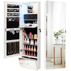 an open mirrored cabinet with cosmetics and makeup products in the bottom section, next to a mirror