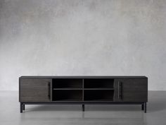 the sideboard is made out of dark wood and has two open compartments for storage