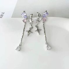 'SOLD AS A PAIR' ❤🦋Discover a touch of whimsy with our stunning **Silver Ear Cuff: Silver Butterfly uniquely adorned with sparkling pink and purple gemstones. Handcrafted with care, each piece reflects a beautiful blend of boho charm and Kawaii aesthetics, perfect for the modern woman who loves to express her individuality. These dainty dangling earrings are designed to catch the light beautifully, making them an ideal accessory for any occasion, from casual outings to special events. Crafted from high-quality, durable silver-plated material, this ear cuff is both lightweight and comfortable to wear. The elegant butterfly design symbolizes transformation and beauty, while the vibrant gemstones add a playful pop of color. Measuring approximately 2 inches in length, these earrings drape del Ear Cuffs Aesthetic, Virtual Angel, Purple Gemstones, Ear Cuff Silver, Earrings Kawaii, Earrings Aesthetic, Korean Earrings, Fancy Earrings, Silver Ear Cuff