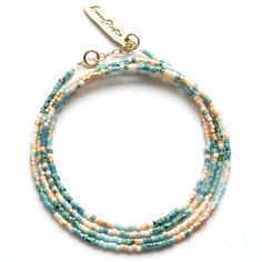 three stranded bracelet with turquoise and white beads on a gold plated hook clasp