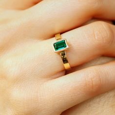 This beautiful Emerald Gold Ring was handmade in Melt'm Jewelry Design Studio in California using 14k solid yellow gold band and 6x4mm emerald cut lab grown emerald stone.  Emerald is featuring in 14k gold thick bezel setting. It's a lovely unisex ring for men and women.   DETAILS ABOUT THE RING, MATERIAL AND STONES Ring Band: 14K solid gold  Ring Band size:  3x1 mm thick flat band Gemstone: Lab grown Emerald Emerald size:   6mm x 4mm  emerald cut Yellow gold or white gold options available from Stackable 14k Gold Emerald-cut Birthstone Ring, 14k Gold Emerald Cut Stackable Birthstone Ring, Stackable Yellow Gold Emerald Ring For Promise, Yellow Gold Stackable Emerald Ring For Promise, 14k Gold Emerald-cut Stackable Rings For May Birthstone, 14k Gold Stackable Emerald-cut Rings For May Birthstone, 14k Yellow Gold Emerald Ring For Promise, 14k Gold Emerald Cut Rings For May Birthstone, Gift 14k Gold Emerald Ring