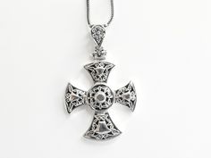 A timeless elegance of Byzantine artistry with this exquisite silver cross. Handcrafted with intricate Byzantine themes and ornate decorations, each detail reflects centuries of rich cultural heritage.  A symbol of faith and sophistication, this cross is a stunning statement piece for any occasion.  Elevate your style and spirituality with this unique treasure from our collection. The silver cross is delivered in a gift box. The chains are not included. Free worldwide shipping with DHL or Fedex. Traditional Cross Jewelry With Intricate Design, Sterling Silver Byzantine Cross Jewelry, Silver Byzantine Cross Jewelry, Byzantine Cross Sterling Silver Jewelry, Byzantine Sterling Silver Cross Jewelry, Byzantine Style Sterling Silver Cross Jewelry, Traditional Silver Cross Necklace, Traditional Silver Cross Necklace Gift, Traditional Silver Cross Necklace As Gift