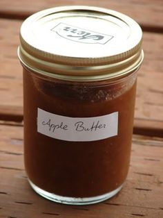 an apple butter jar sitting on top of a wooden table