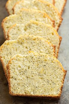 slices of lemon poppy seed bread lined up on a baking sheet, ready to be eaten