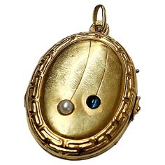 Antique 14k gold russian locket pendant centered with 1 natural blue sapphire stone and white pearl with total gold weight of 5 grams and 4cm lenght in detailed workmanship pendant was made in odessa durung the imperial russian era 1907.c hall marked 56 imperial russian gold stamdard and odessa assay mark and initial maker in cyrllic alphabet