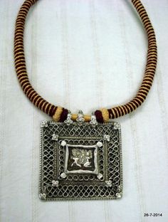 VINTAGE ANTIQUE COLLECTIBLE TRIBAL OLD SILVER PENDANT NECKLACE FROM RAJASTHAN INDIA. NICE DESIGN OLD SILVER PENDANT RE-STRUNG WITH COTTON CORD IN TRADITIONAL STYLE. GREAT PIECE FOR ETHNIC JEWELRY COLLECTOR OR FOR TRIBAL STYLE BELLY DANCE. SUBJECT OF THIS AMULET IS HINDU GODDESS LAXMI (GODDES OF WELTH) AND LORD GANESHA (GOD OF MIND AND LUCK).Length - 45 cm(17.7")we can adjust the length.Pendant size - 7/6.4 cmweight - 70 gramsMaterial - silver & original old worn piece. Antique Finish Silver Temple Necklace As Gift, Temple Style Metal Pendant Necklace, Vintage Silver Temple Necklace With Intricate Design, Silver Temple Necklace With Antique Finish As Gift, Metal Pendant Temple Necklace, Antique Silver Necklaces For Festivals, Pendant Necklace For Puja And Navratri, Traditional Locket Jewelry For Navratri, Antique Jewelry With Intricate Design For Puja