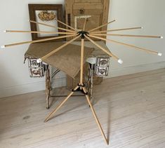 a chair made out of wooden sticks and some other things on the floor in front of a door