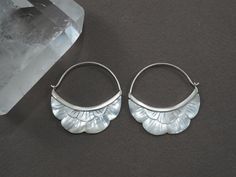 * Pair of Crescent Moon Hoops. * Hand-carved in mother-of-pearl. * Solid Sterling silver bezel and clasp. * 1.5" drop, 1.5" diameter hoop. Lightweight and gorgeous! Beautifully carved mother of pearl flowers set in a solid sterling bezel with standard gauge ear-wire for all standard pierced ears. Both sides of each earring are carved with the same care and intricacy.  Perfect for every occasion, from everyday wear to a special night out. DAILY WEAR: Gently remove the ear-wire from the clasp and Silver Mother Of Pearl Round Pearl Earrings, Handmade Silver Hoop Pearl Earrings, Nickel-free Silver Mother Of Pearl Earrings, Pierced Round Mother Of Pearl Jewelry, Handmade Silver Shell-shaped Pearl Earrings, Flower Hoop Earrings, Ear Gauges, Moon Flower, Mother Pearl