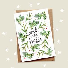 a christmas card with the words deck the hall on it and evergreen branches in red berries