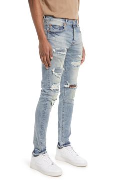 An assortment of rips, shredding and deep fading amplifies the lived-in appeal of light-washed skinny jeans. 12" leg opening; 10" front rise; 14" back rise 98% cotton, 2% Lycra® spandex Machine wash, line dry Imported Asian Owned/Founded Rugged Distressed Fitted Bottoms, Rugged Fitted Distressed Bottoms, Rugged Fitted Distressed Jeans, Urban Style Ripped Faded Jeans, Urban Style Faded Ripped Jeans, Rugged Ripped Faded Jeans, Rugged Faded Ripped Jeans, Urban Style Distressed Light Wash Jeans, Urban Distressed Light Wash Jeans