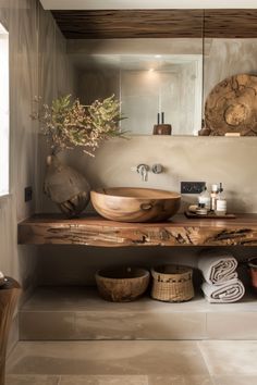 a bathroom with a sink, mirror and wooden bowl