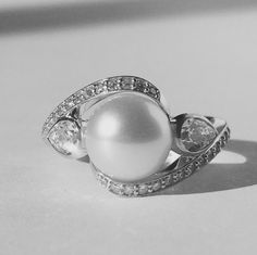 Timeless Pearl Ring With Diamond Accents, Elegant Silver Rings With Timeless Design, Timeless Diamond Pearl Ring With Center Stone, Timeless White Gold Pearl Ring With Diamond Accents, Elegant Diamond White Brilliant Cut Pearl Ring, White Gold Diamond Rings With Timeless Design, White Timeless Wedding Jewelry, Elegant Pearl Ring With Diamond In Round Cut, Timeless Diamond-white Pearl Ring With Diamond Accents