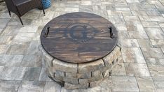 a wooden table sitting on top of a brick patio