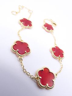 "Luxurious & Classic! This exquisite clover flowers bracelet features 18kt gold plated 5 pieces red carnelian 5 petal clover flower charms on thin links chain. Measuring 7 1/2\" long total with adjustable ring chain and sturdy lobster claw clasp, the gorgeous dainty clovers bracelet looks elegant in a timeless sophisticated classic style. ☆ Specifications: * 18kt Gold Plated / Red Carnelian Clover Flowers * MEASURES:  7 1/2\" Long Adjustable Chain / LOBSTER CLAW CLASP CLOSURE * CLOVER FLOWERS:  10mm Diameter ☆ FREE SHIPPING WITHIN THE USA VIA USPS GROUND ADVANTAGE MAIL. INTERNATIONAL SHIPPING IS ONLY $16.95 USD VIA USPS FIRST CLASS EXPEDITED INTERNATIONAL MAIL SERVICE. ☆ THANKS FOR LOOKING!" Red Carnelian, Clover Flower, Ring Chain, Bracelet Dainty, Flower Bracelet, Flower Charm, Chain Ring, Chain Link Bracelet, Adjustable Rings