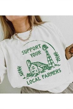 a woman wearing a white shirt that says support your local farmers