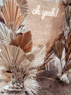 an arrangement of palm leaves with the words ok yeoh on it in white letters