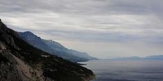 there is a view of the ocean and mountains on this cloudy day with no clouds