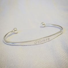 The Silver Tree Sterling Silver Jewellery Silver Childs Bracelet This pretty torque style sterling silver bracelet is the perfect gift for a childs birthday, name day or christening.   Your choice of name is hand stamped across the front, I can engrave approximately 10 characters on the front on the bracelet. The bracelet measures approx 5cm diameter, it is 12cm in length with an opening of about 3cm and can be gently adjusted to fit a baby or child.   Please ensure you type in your choice of name precisely as I cannot accept returns due to inaccuracies. This can be left in a message at checkout Please note that the characters are hand stamped so there may not be perfect alignment like you will find with machine made jewellery giving an artistic finish.  This item is handmade to order. Eac Adjustable White Gold Bracelets For Mother's Day, Adjustable Hypoallergenic Sterling Silver Anniversary Bracelet, Adjustable Hypoallergenic Sterling Silver Bracelet For Anniversary, Personalized Adjustable Sterling Silver Bracelet, Hypoallergenic Sterling Silver Bracelet For Mother's Day, Adjustable White Gold Bracelet For Birthday, Personalized Sterling Silver Name Bangle, Personalized Sterling Silver Name Bracelet Bangle, Sterling Silver White Gold Bracelet With Name