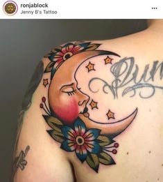 the back of a woman's shoulder with a moon and stars tattoo on it