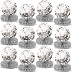 a bunch of white and black balls on top of each other with ribbons around them