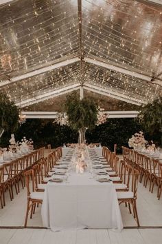 the tables are set with white linens and place settings for an elegant wedding reception