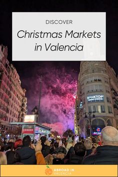 people watching fireworks in the city at night with text overlay that reads discovering christmas markets in valencia