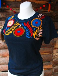 "Mexican embroidered shirt Beautiful embroidered blouse. This is handmade in Mexico. Perfect for those summer days at the beach, or for your fiesta parties. The embroidery colors may vary due all the handmade work (not the design). If you want an specific color, please send us a message so we can send you the ones available so you can choose. Size: Extra Small: 13\" width x 22\" long Small; 14\" width x 23\" long Medium: 15 1/2\" width x 24\" long (Width: shoulder - shoulder) Please also notice Multicolor Floral Embroidery T-shirt For Summer, Bohemian Cotton Tops With Machine Embroidery, Bohemian Tops With Machine Embroidery, Traditional Embroidered Summer T-shirt, Summer Embroidered Top With Motif, Summer Folk Style Embroidered Top, Bohemian Embroidered Summer T-shirt, Festival Multicolor Top With Floral Embroidery, Multicolor Embroidered Crew Neck Top For Summer