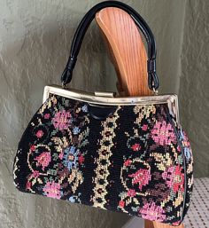 "Vintage 1970s? Dave Brand tapestry bag Structured purse, top handle Tapestry, black leather handle, black cloth inside, interior clean, no rips. Hinged opening with gold tone frame, frame has small amount of tarnishing (pictured) Four metal feet on bottom, snap lock works great.  Approx. Dimensions: 7 1/2\" height 5 1/2\" top handle height 11 1/2\" width 4\" depth Purse has slight old smell, but overall great condition" Vintage Tapestry Shoulder Bag With Leather Handles, Vintage Evening Satchel With Leather Handles, Vintage Black Handheld Satchel, Vintage Tapestry Bags With Leather Handles, Vintage Tapestry Bag With Detachable Handle, Vintage Black Satchel With Leather Handles, Vintage Black Shoulder Bag With Leather Handles, Vintage Black Top Handle Satchel, Vintage Tapestry Satchel With Top Handle