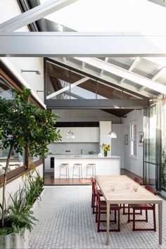 an open kitchen and dining area with white walls