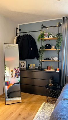 a bedroom with a bed, mirror and shelves on the wall in front of it