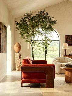 a living room filled with furniture and a tree