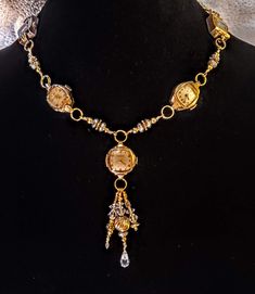 This  necklace has 5 beautiful vintage watches, at least one of which is stamped 10K gold plated bezel. Dangling form the center watch are gold filled beads as well as silver tone beads and some clear crystals for sparkle. Links that I made to separate the other watches are also comprised of gold tone, gold filled and silver beads. The clasp is a large lobster claw clasp. This one is stunning! These necklaces make a statement and are perfect for anyone who loves vintage or steampunk style. Wear Timeless Brass Jewelry For Anniversary, Antique Gold Round Jewelry And Watches, Timeless Antique Gold Jewelry Gift, Timeless Antique Gold Medallion Jewelry, Gold Heirloom Jewelry With 17 Jewels, Timeless Yellow Gold Jewelry With Vintage Charm, Bohemian Yellow Gold Jewelry For Anniversary, Vintage Gold Beaded Jewelry, Vintage Formal Jewelry With Gold Beads