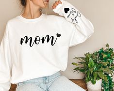 Personalized Mom Sweatshirt With Kids Name On Sleeve, Mothers Day Hoodie, Custom Est Date Mom Hoodie, Grandma Sweatshirt , Gift For Mommy Thank you so much for choosing us! How To Order 1️⃣ Please review all the information provided before placing an order. 2️⃣ Select the shirt type and size using the drop down menu. 3️⃣ Select the color of the shirt using the following drop down menu. 4️⃣ Once all your desired items are in your cart you may complete your order by entering your payment method, d White Crew Neck Hoodie For Mother's Day, White Cotton Hoodie For Mother's Day, White Cotton Sweatshirt For Mother's Day, Casual White Sweatshirt For Mother's Day, Long Sleeve Hoodie With Letter Print For Mother's Day, Grandma Sweatshirt, Mom Hoodies, Mom Sweatshirt, Kid Names