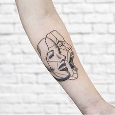 a woman's face on the arm with a black and white line work tattoo