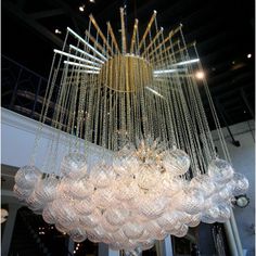 a large chandelier hanging from the ceiling in a room with lots of lights